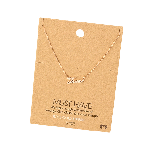 Gold necklace on a card with 