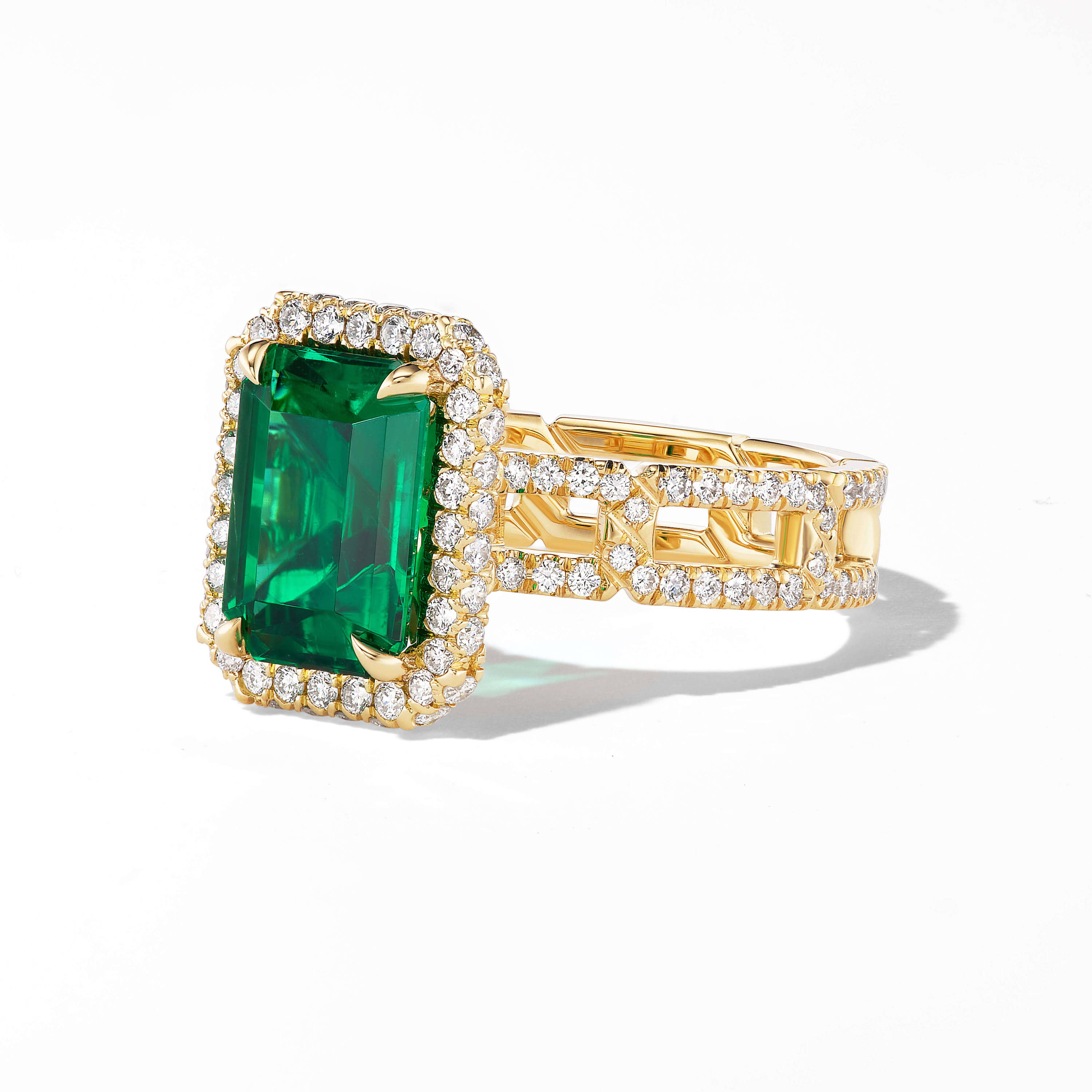 emerald engagement ring with wrapped halo and pave links band