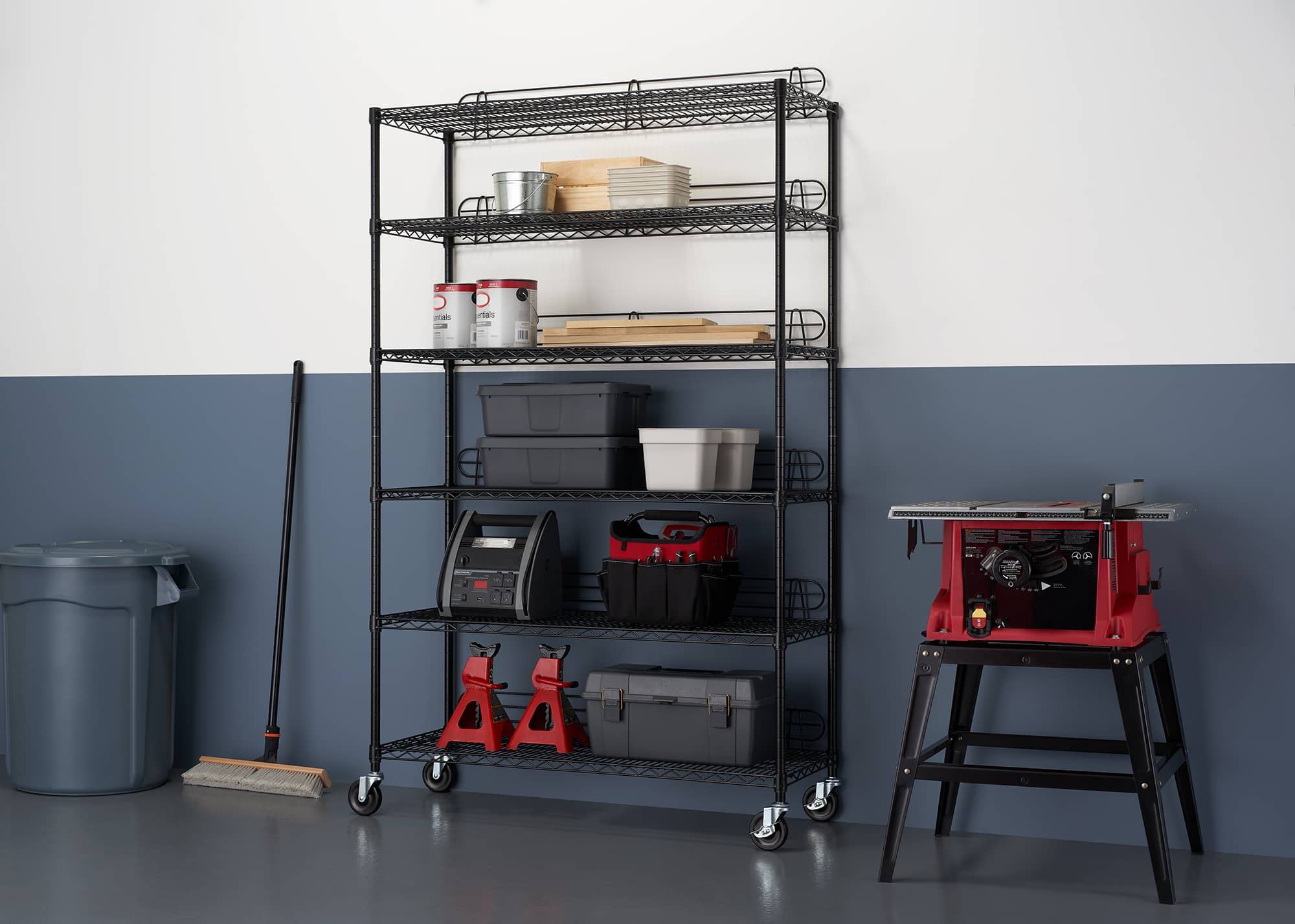 tall black wire shelving rack for garage use, filled with wood working tools and materials, tool boxes, and more