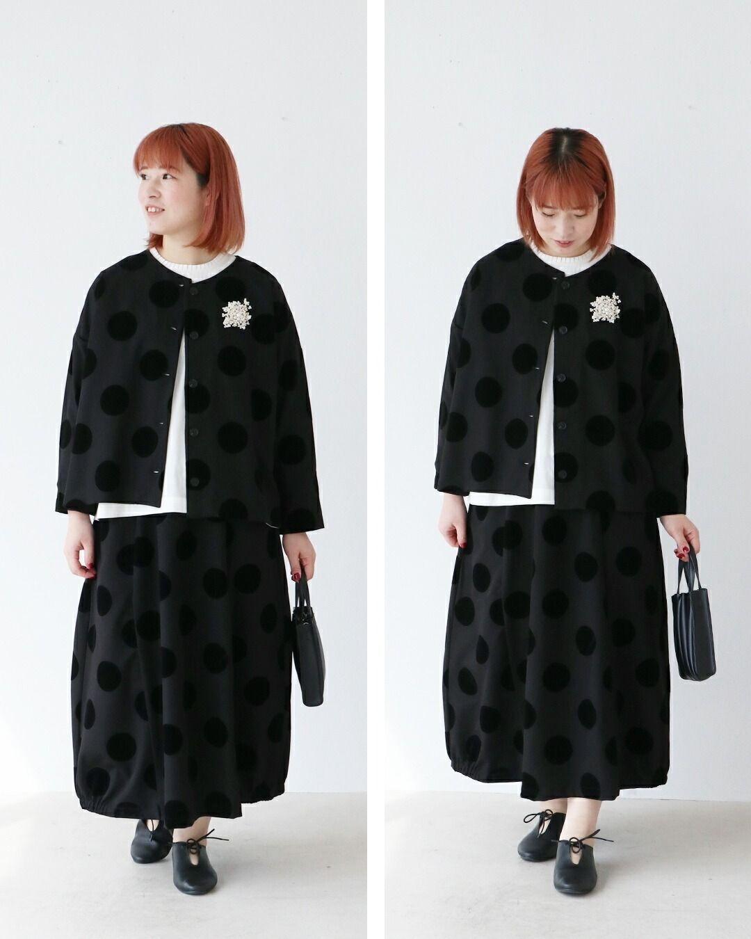 Woman in polka dot outfit, standing in a minimalist setting.
