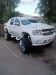Front three-quarter lifted white 2013 Chevy Avalanche chrome wheels off-road tires Psychoblasters V2 horn kit Melvin's HornBlasters featured customer install gallery photo 1