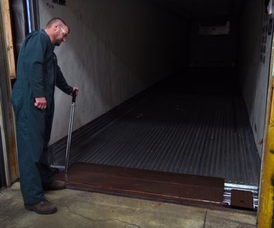 Man using a manual dock leveler