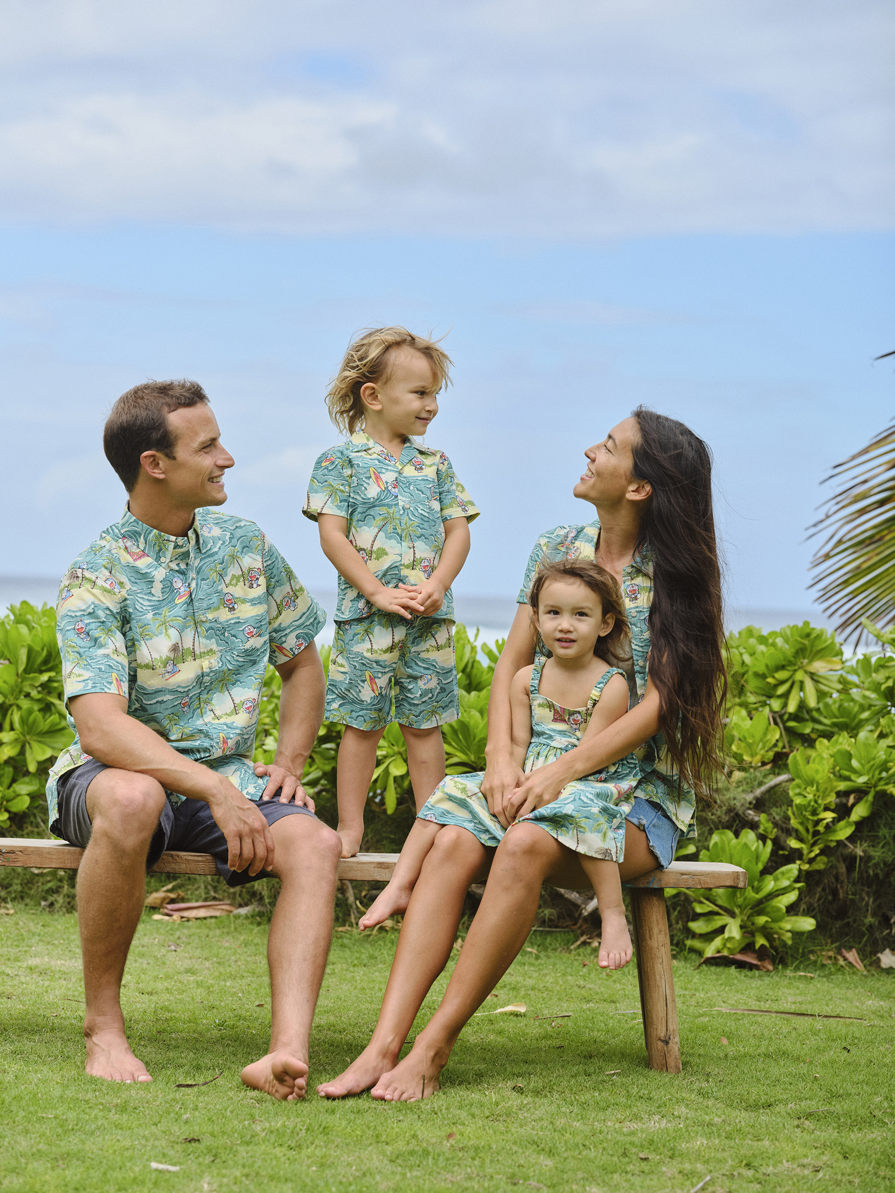 Family in matching outfits enjoying a sunny day outdoors.