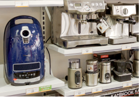 Various kitchen appliances on display, including a vacuum and coffee machines.