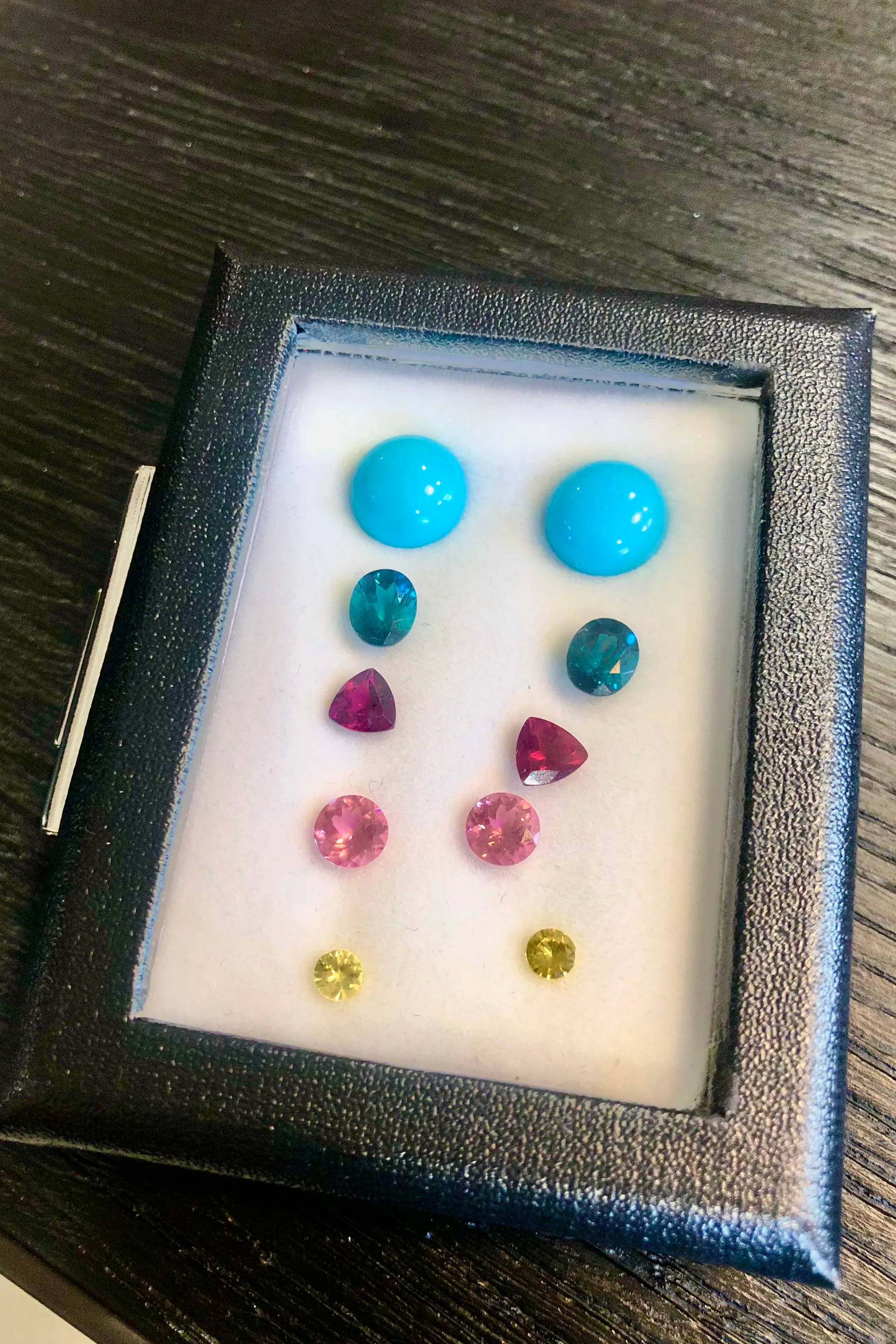 multicolored gemstones in a box