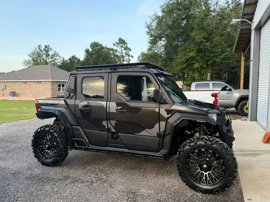 Side profile camo wrap Polaris Xpedition XP5 four-door roof rack beadlock wheels gravel driveway Shane's Compact Electric horn featured customer install gallery photo 1