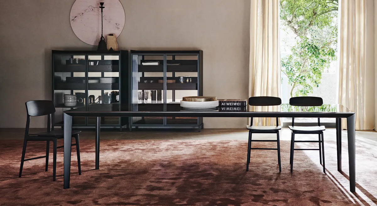 Modern Molteni dining room with a glass table, chairs, and natural light.