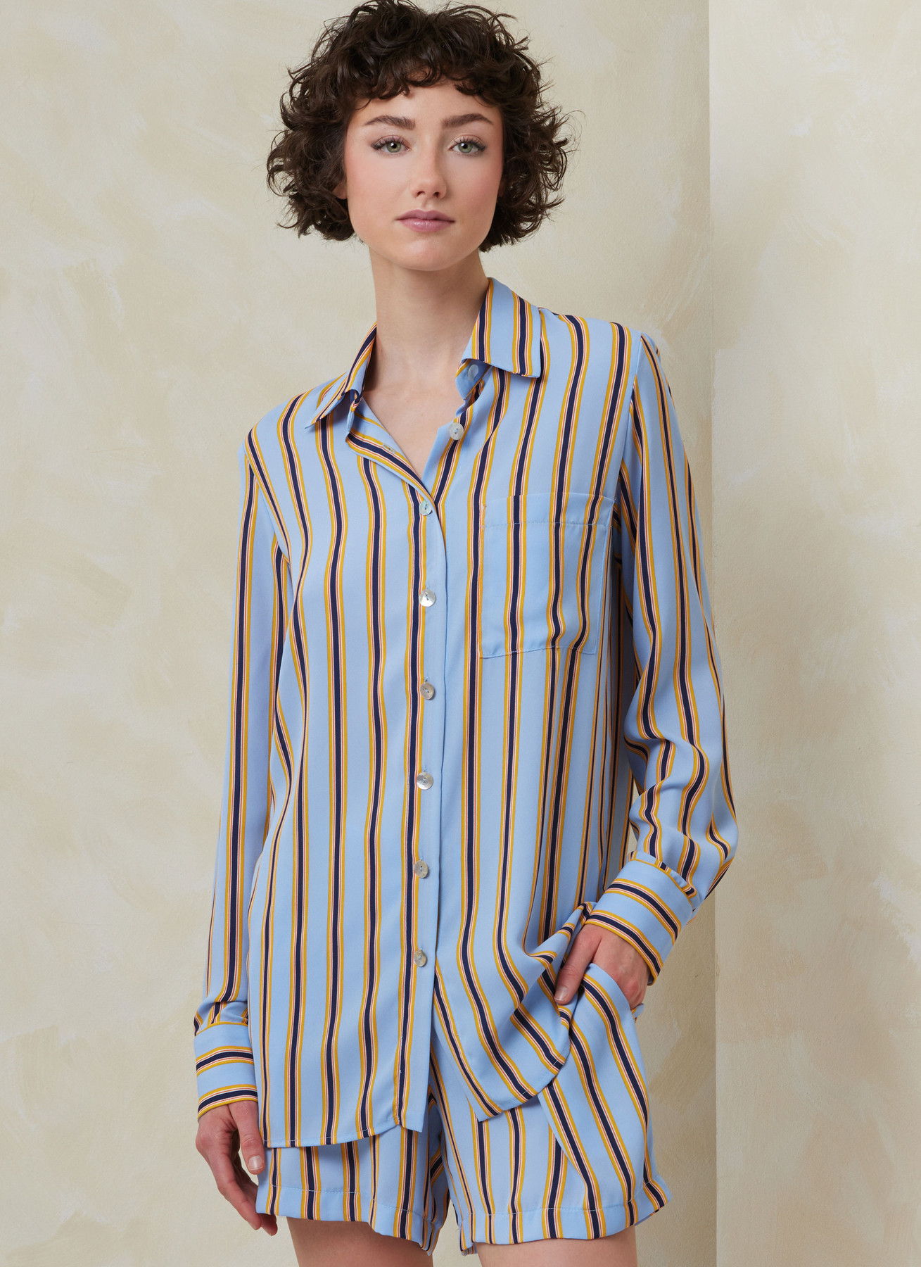 Woman wearing a striped pajama set with a relaxed style.