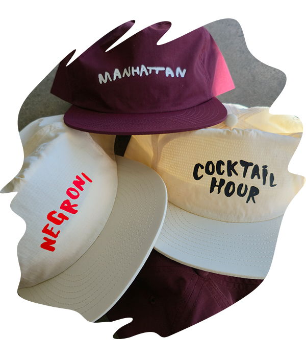Collection of caps in burgundy, yellow, and ecru with bar and cocktail-themed DTF printed text including 