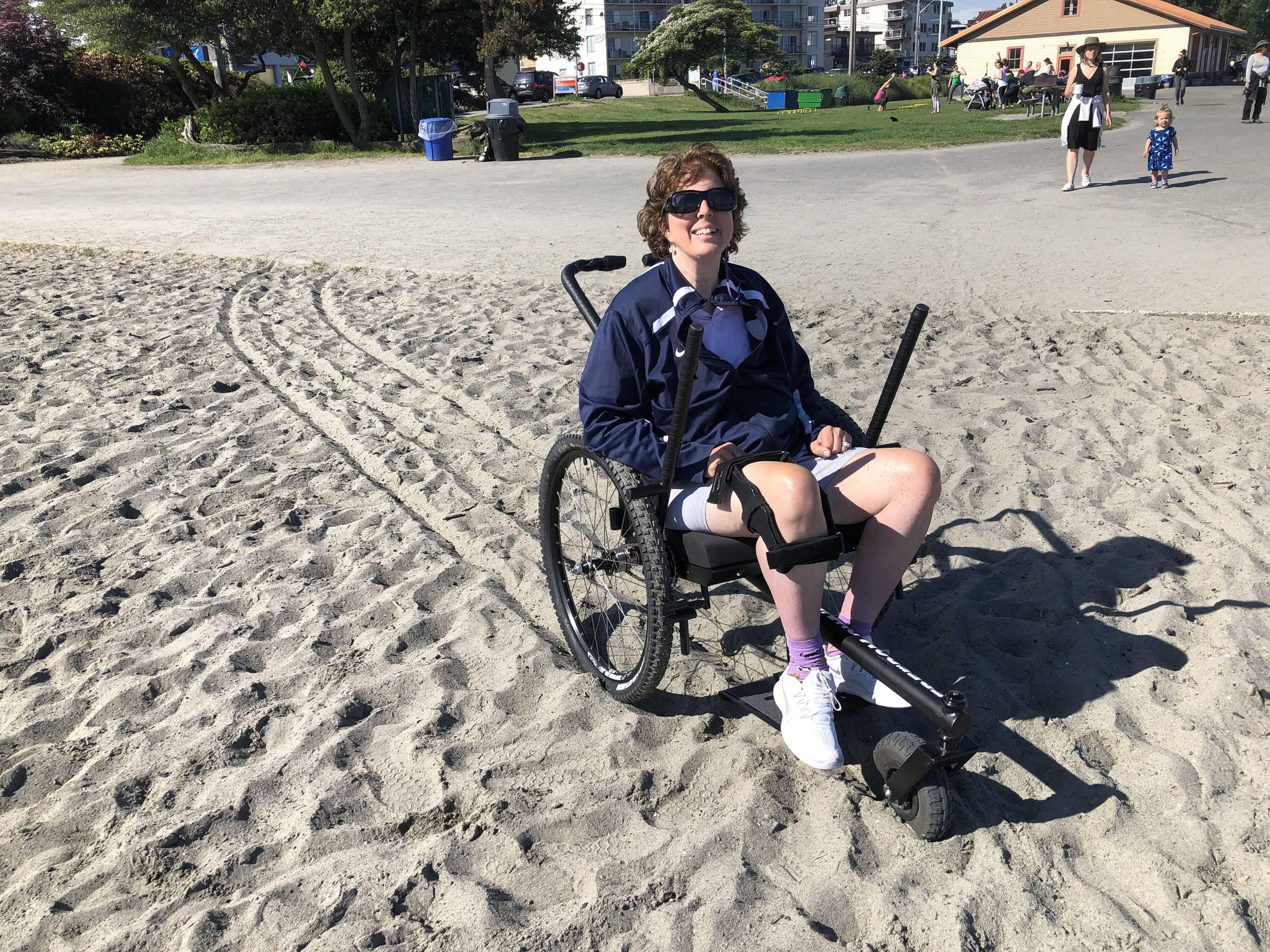 Adult using GRIT Freedom Chair on beach sand off path