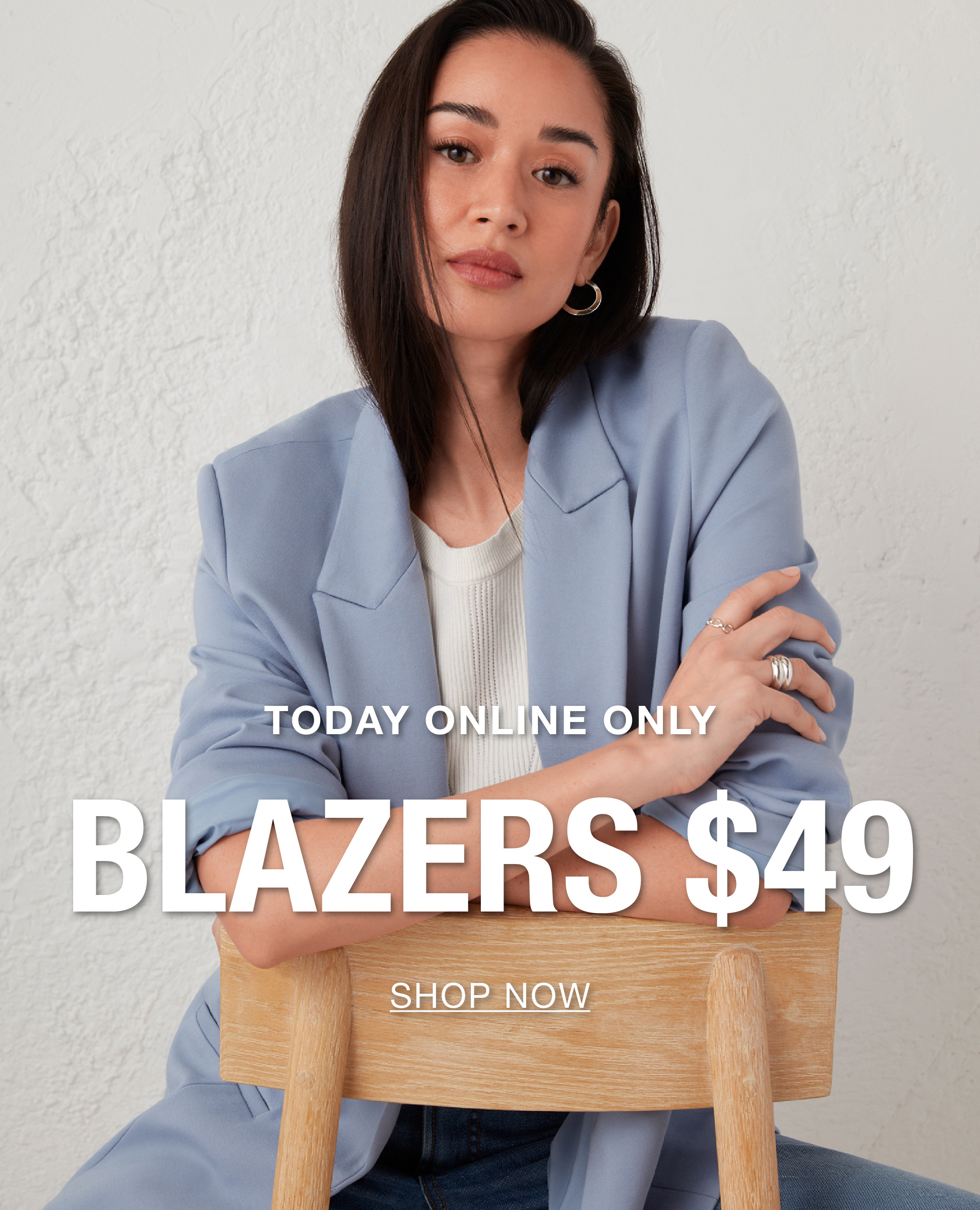 Woman in a blue blazer promoting blazers for $49.