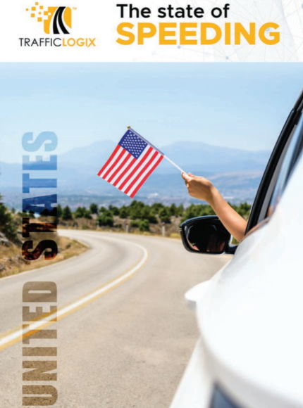 A hand holding an American flag out of a car window.