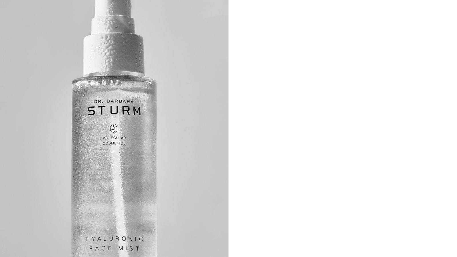 A clear spray bottle with a white cap, labeled 