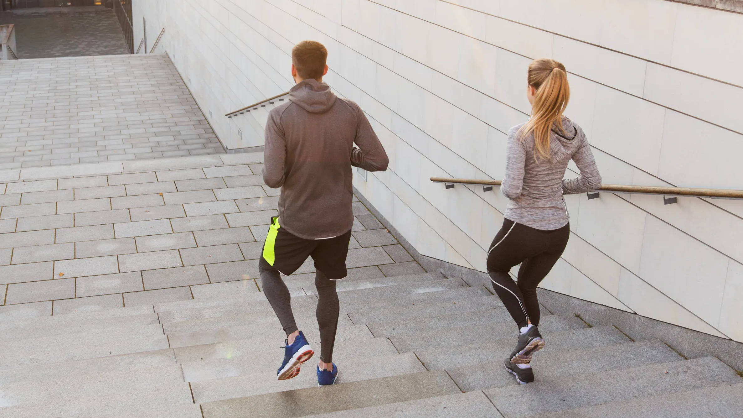 Couple running down stairs