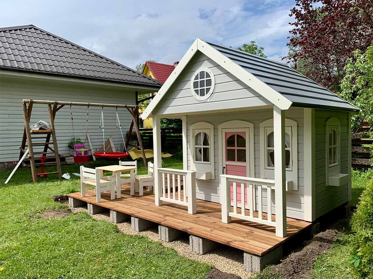 Pink and grey Custom Playhouses with round top window and wooden terrace by WholeWoodPlayhouses