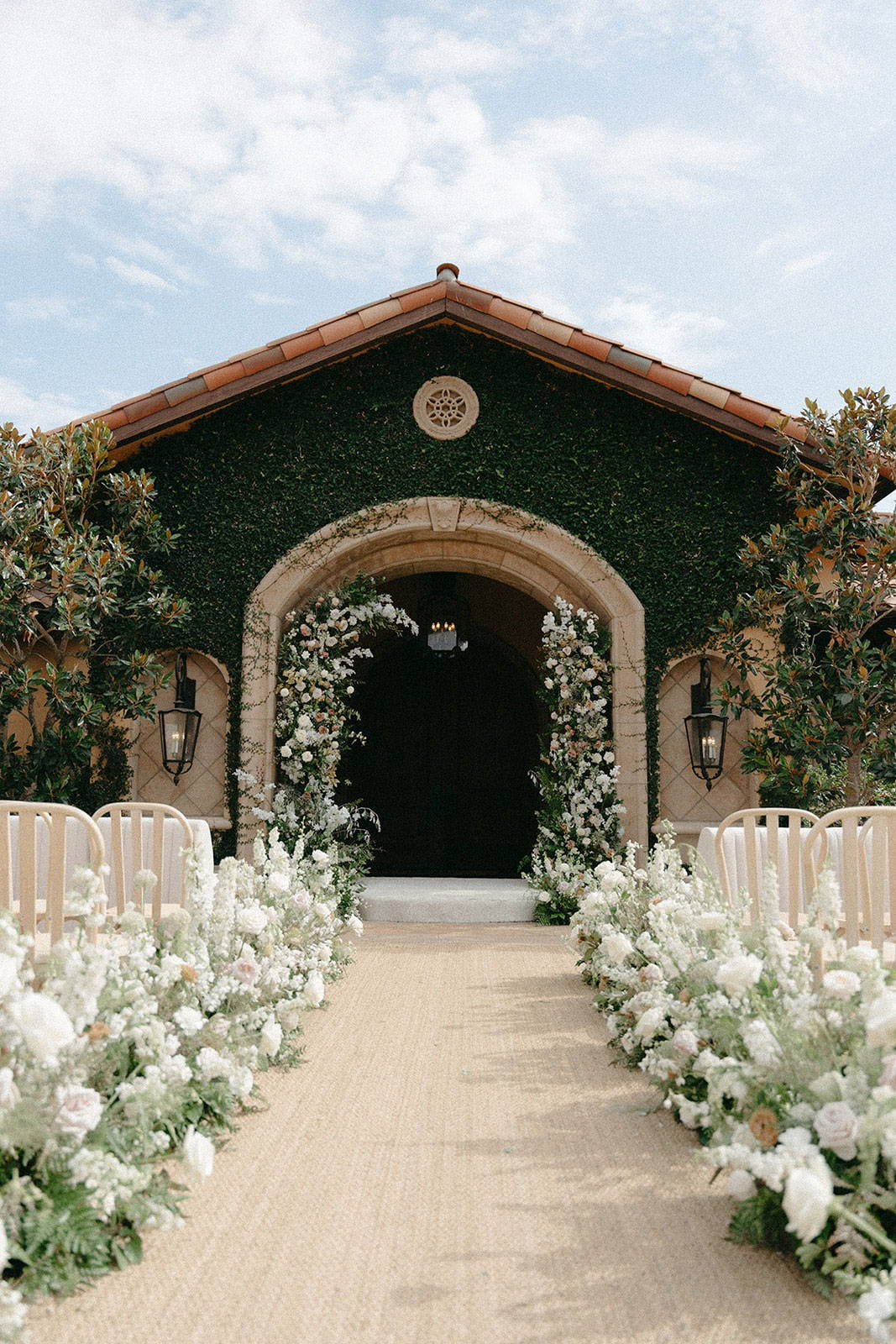 Wedding ceremony aisle and floral bouquets lining the chairs