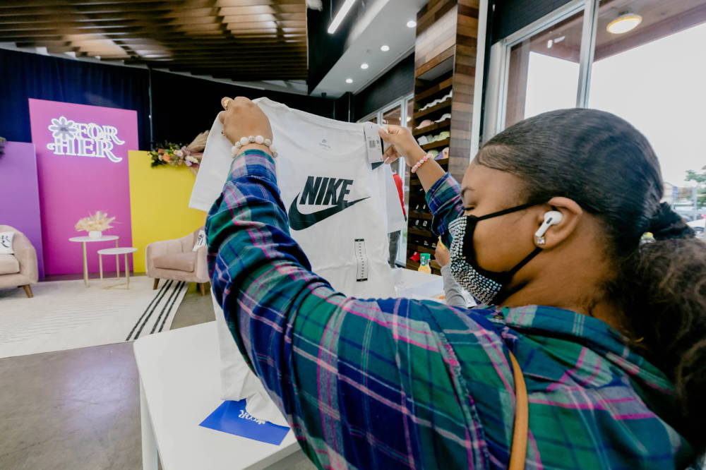 girl holding up nike shirt at for her event