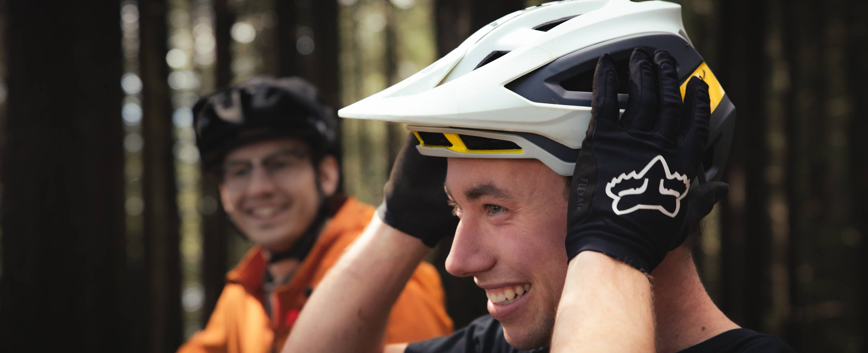Tor wearing the Fox SpeedFrame Pro mountain bike helmet in the blocked colorway and smiling because he loves his new helmet so much