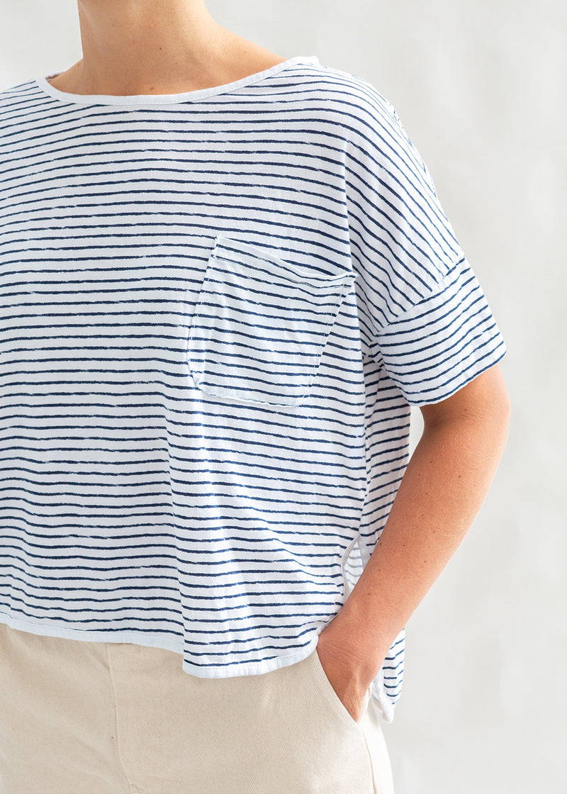 A model wearing a horizontal striped t-shirt