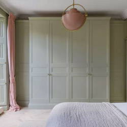 A cozy bedroom painted a light green.