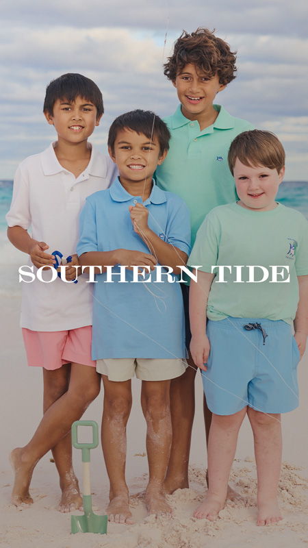 Four boys in colorful shirts standing on the beach with text overlay.