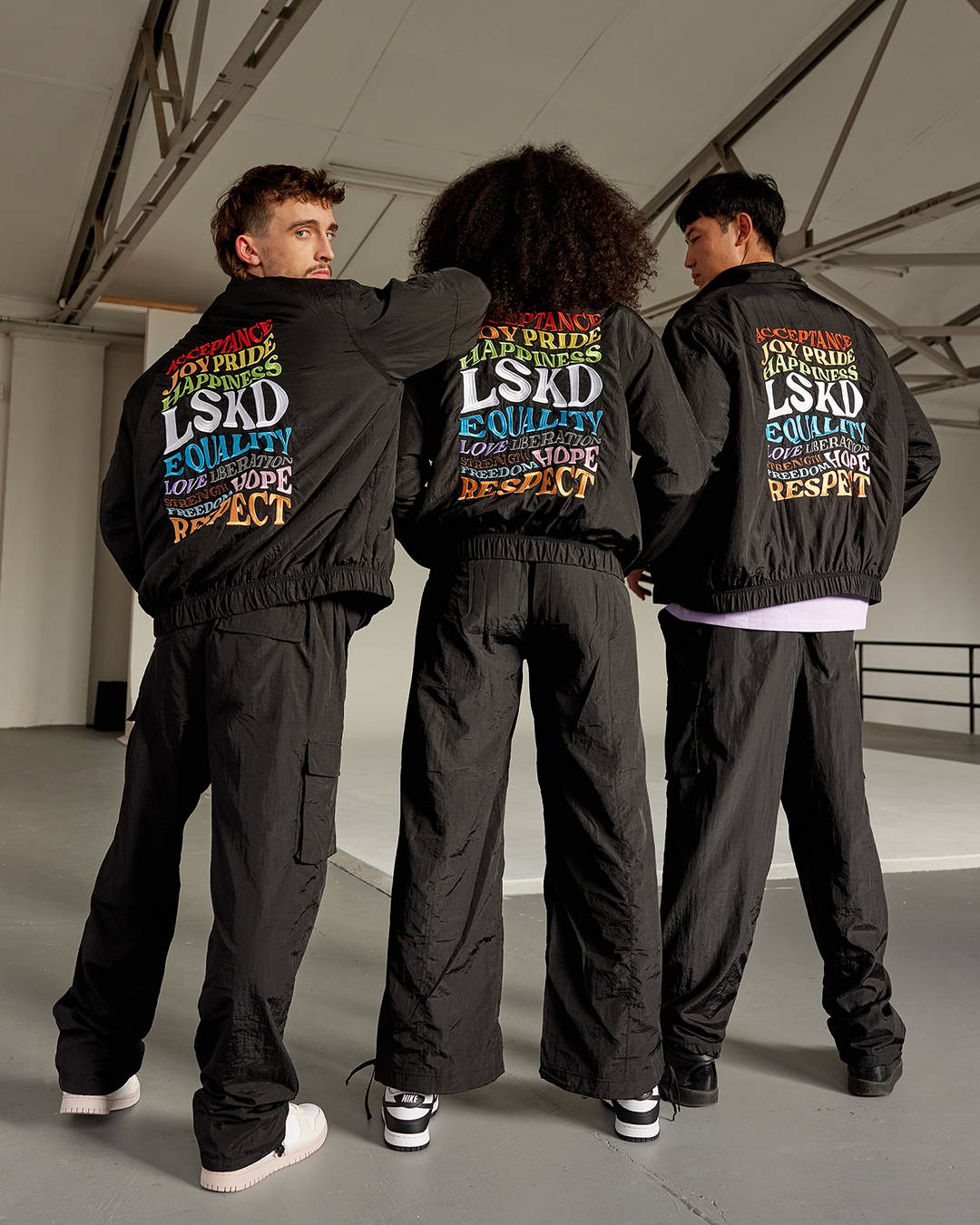 3 people in pride jackets