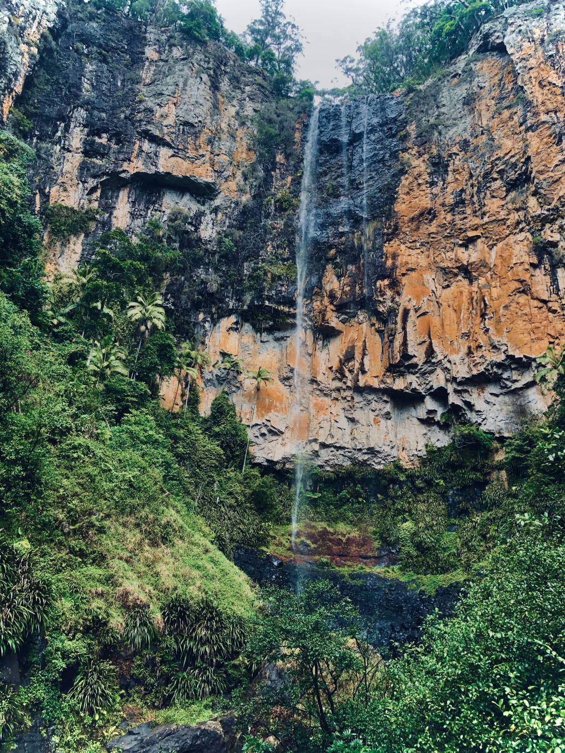 A trickling waterfall cascading down a cliff's edge