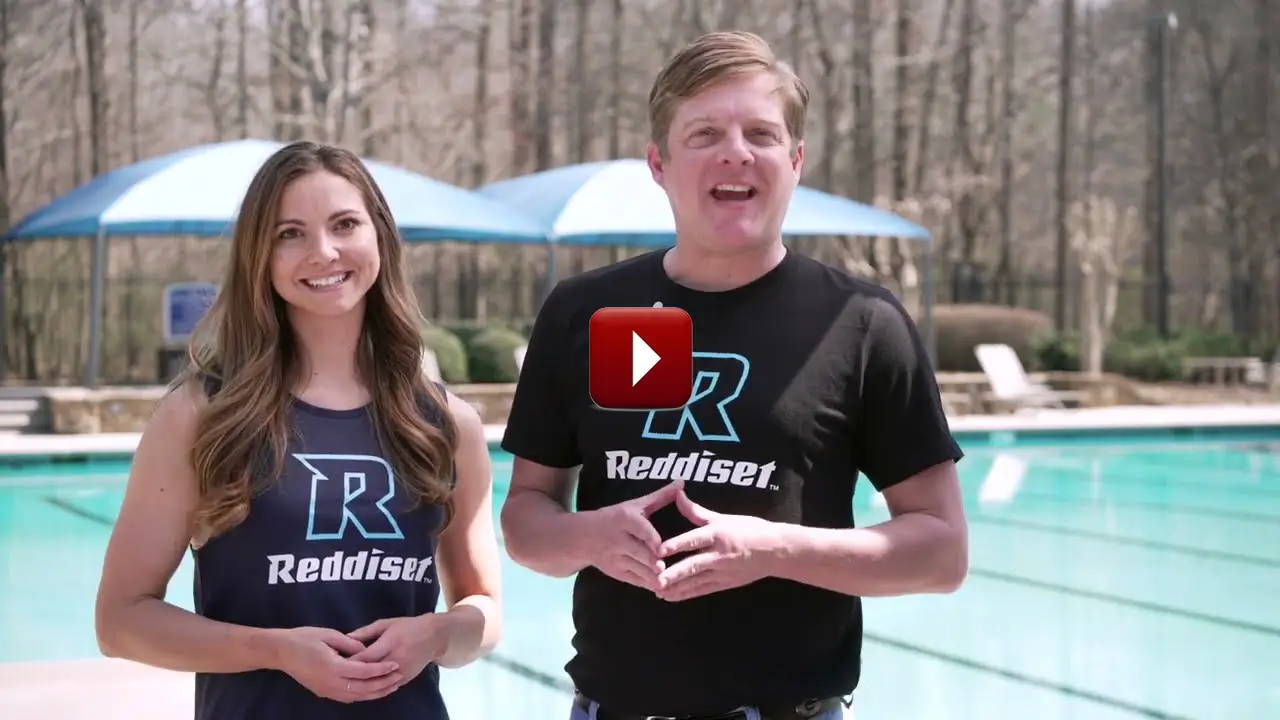 Reddiset employees near a pool discussing team outfitting by Reddiset