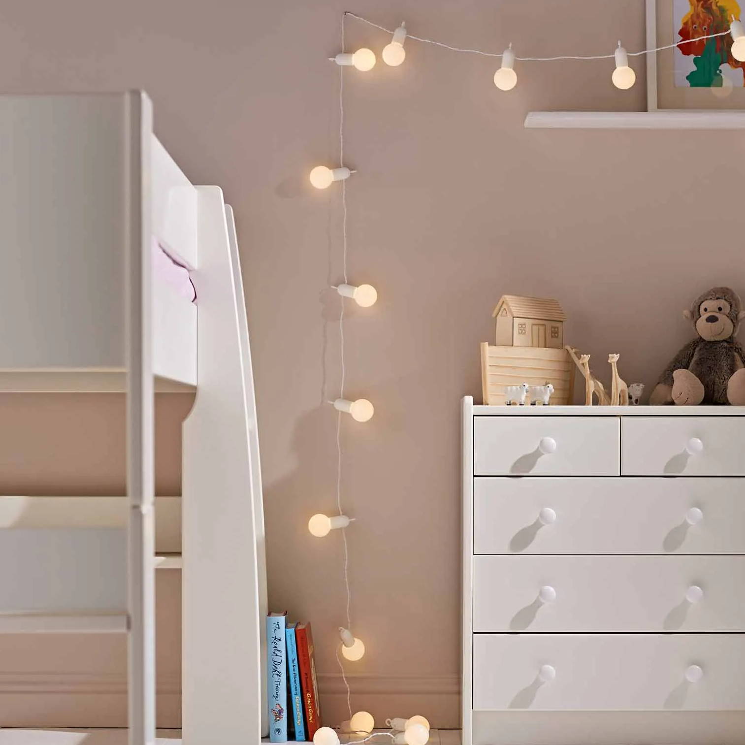 Festoon lights with white cable draped across children's bedroom wall