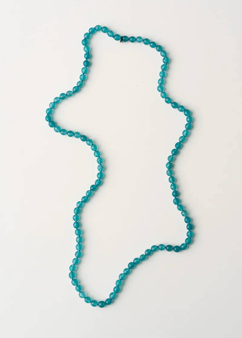 A chunky glass beaded necklace in aqua blue tones