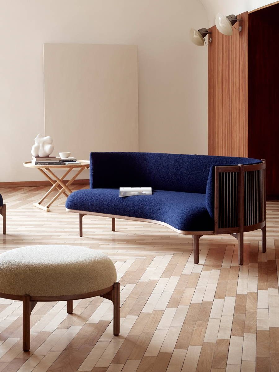 A modern living room featuring a blue Sideways sofa by Carl Hansen and wooden flooring.