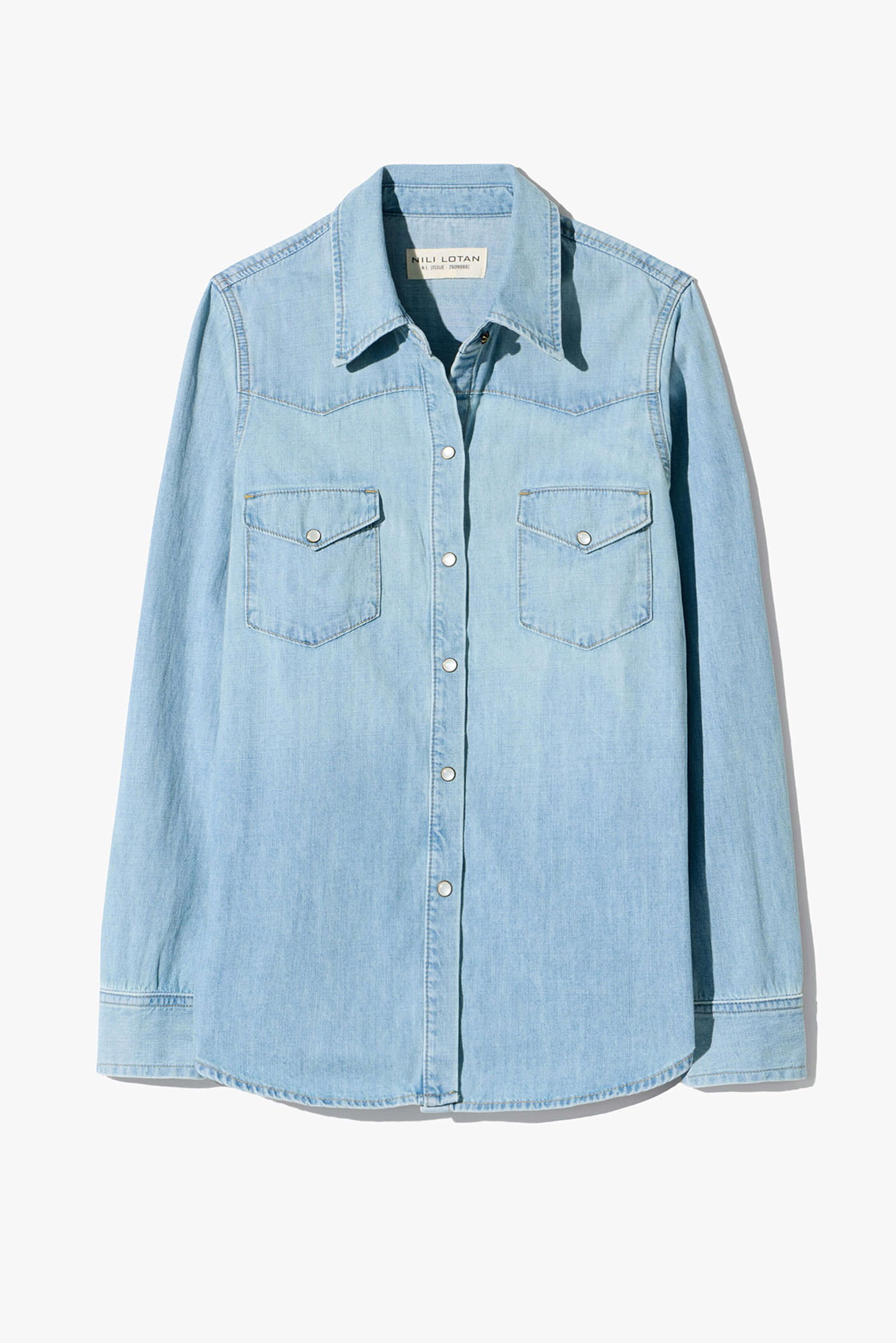 Light blue denim shirt with two front pockets and button closure.
