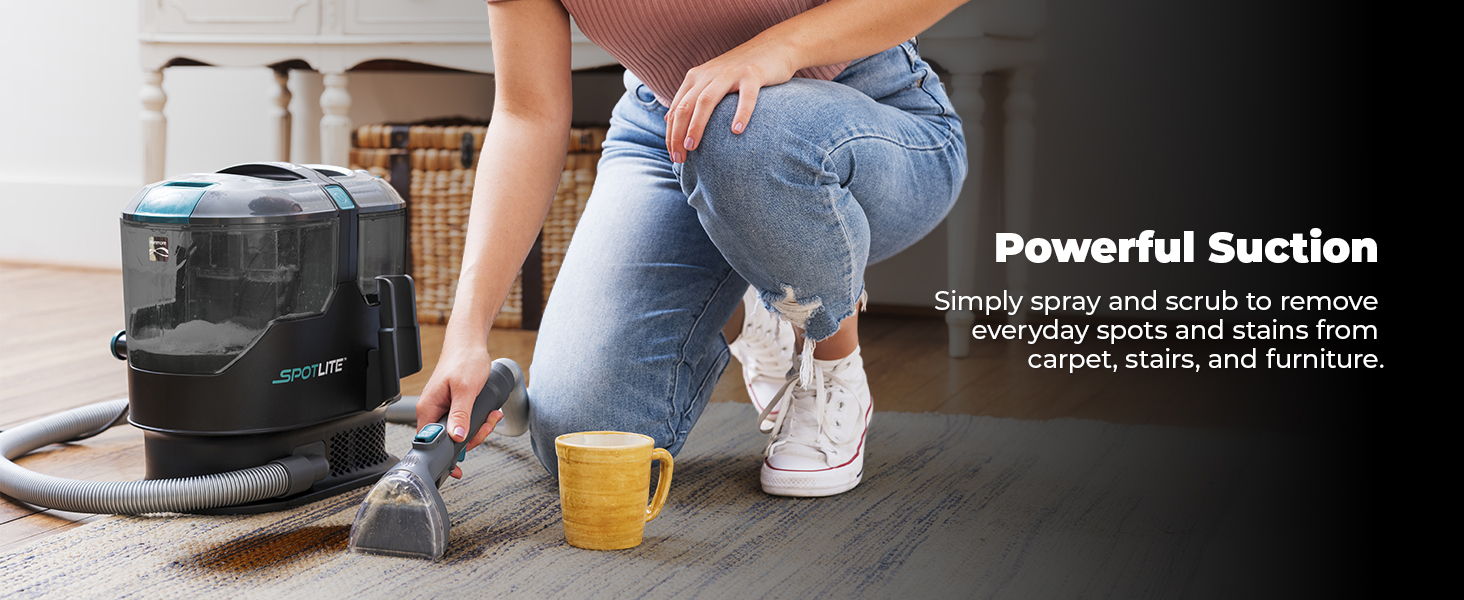 Person vacuuming a carpet with a powerful suction cleaner.