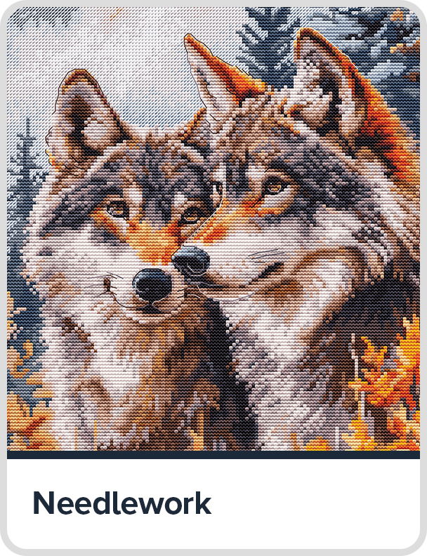 Two wolves in a forest setting, surrounded by autumn foliage.