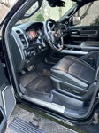 Driver interior of black RAM truck showing custom horn toggle switch on dashboard