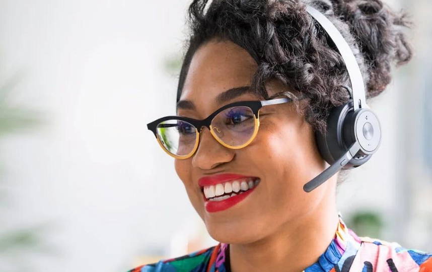 Woman smiling with Logitech headset on