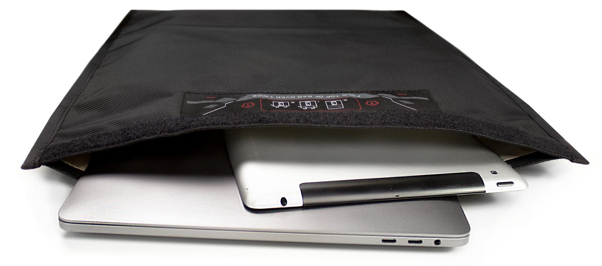 A laptop, a tablet and a phone sliding out of the open Faraday bag