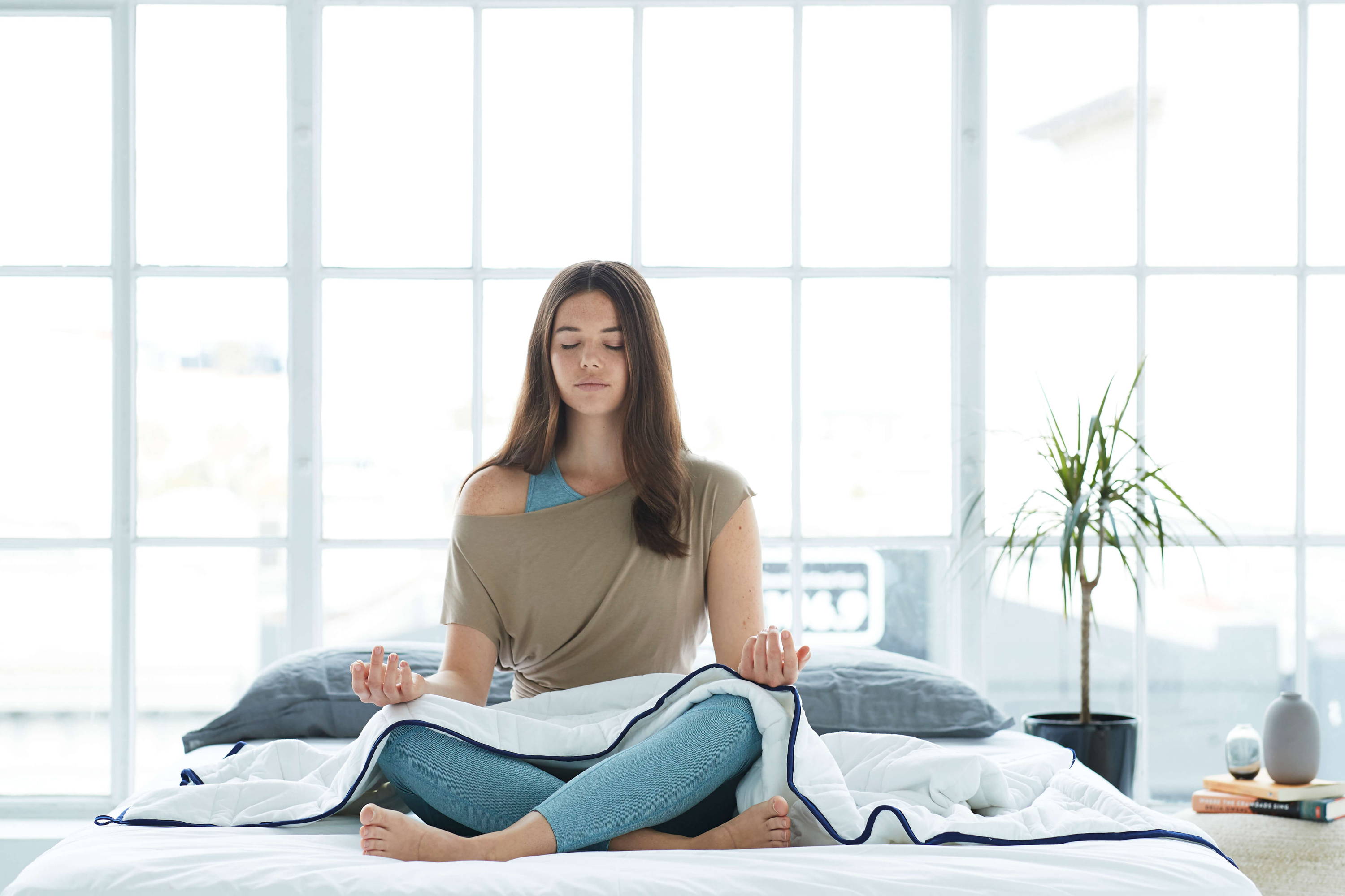 Girl meditating with Groundd Weighted Blanket