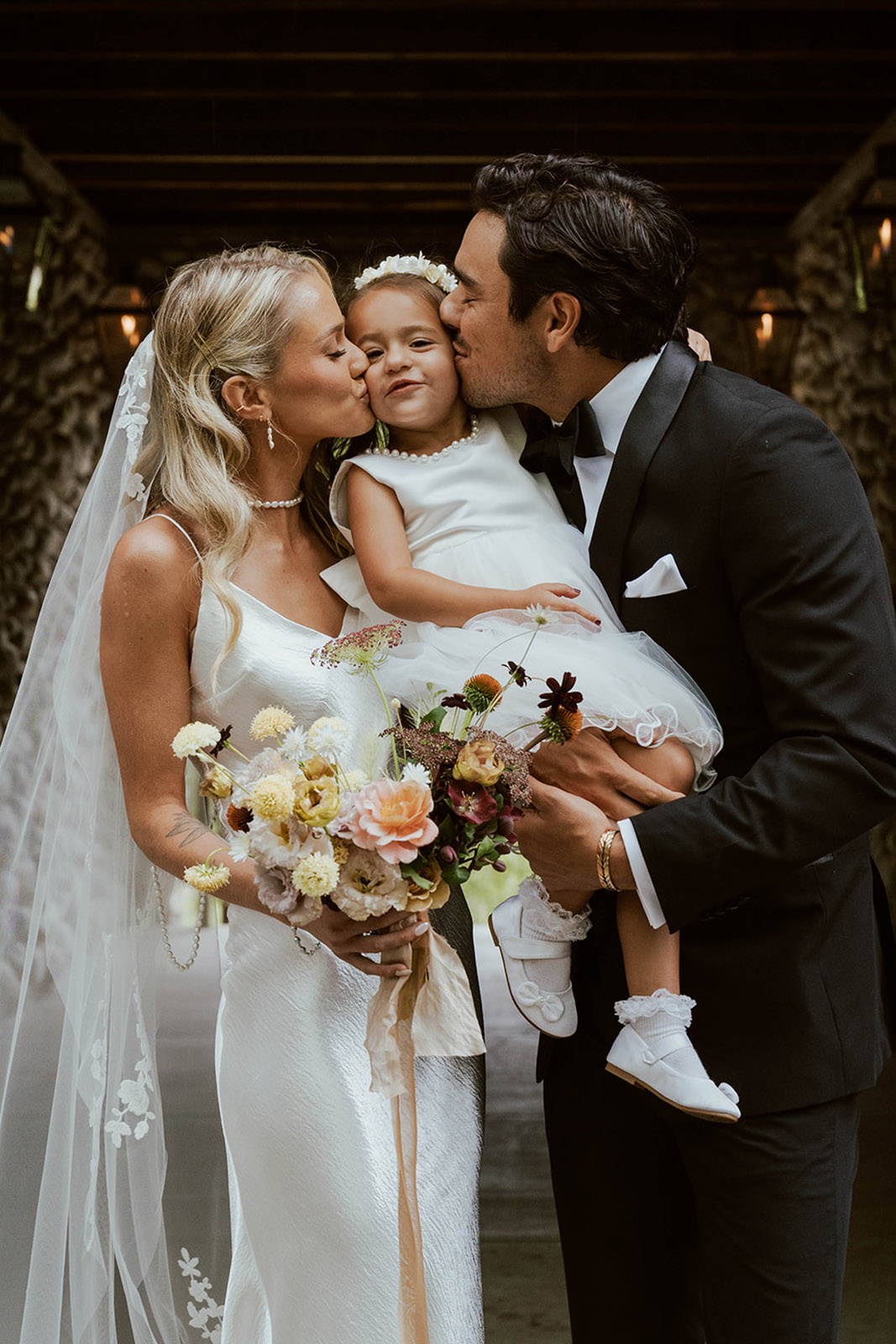 Bride and groom with their flower girl
