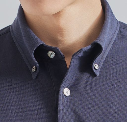 Close-up of a person's collar on a dark shirt.
