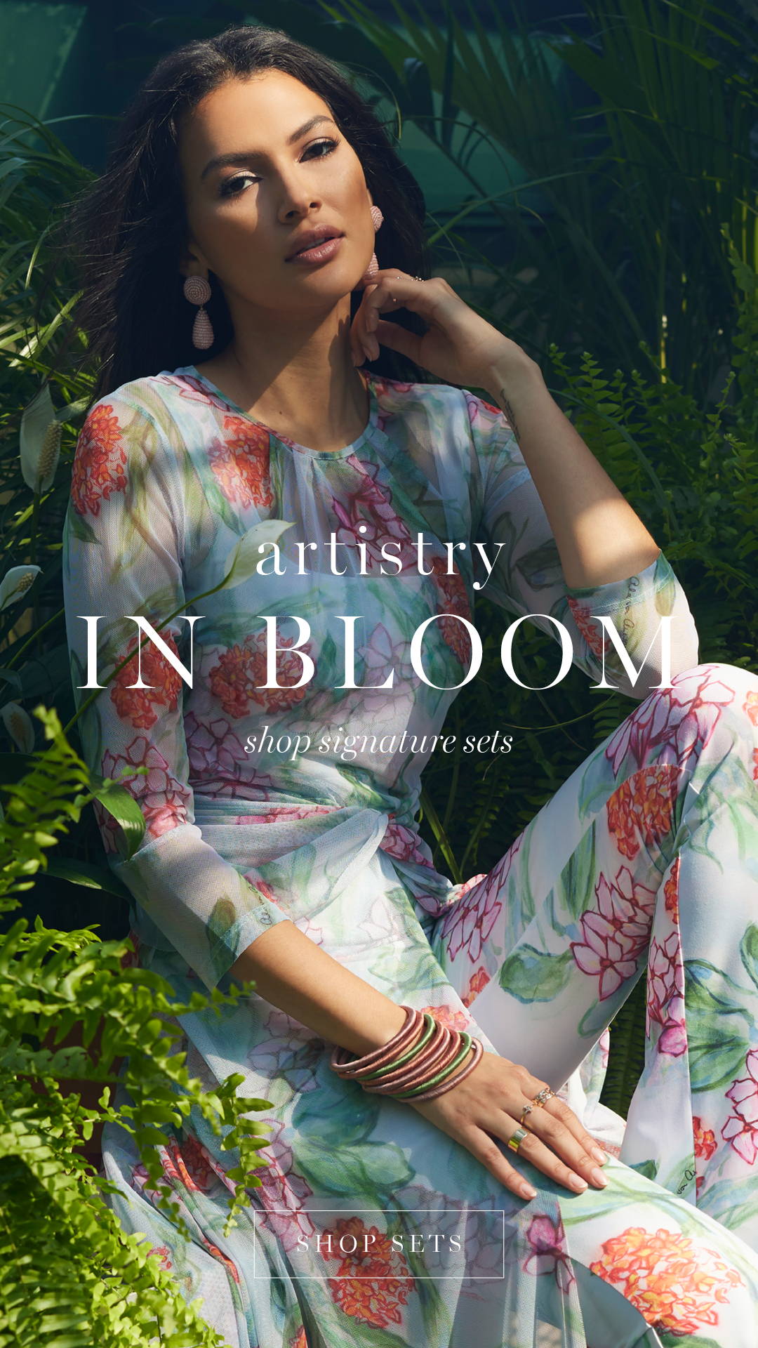 aristry IN BLOOM | Woman wearing outfit set consisting of stretch knit tank top pants and mesh topper in a matching floral print | Shop Sets