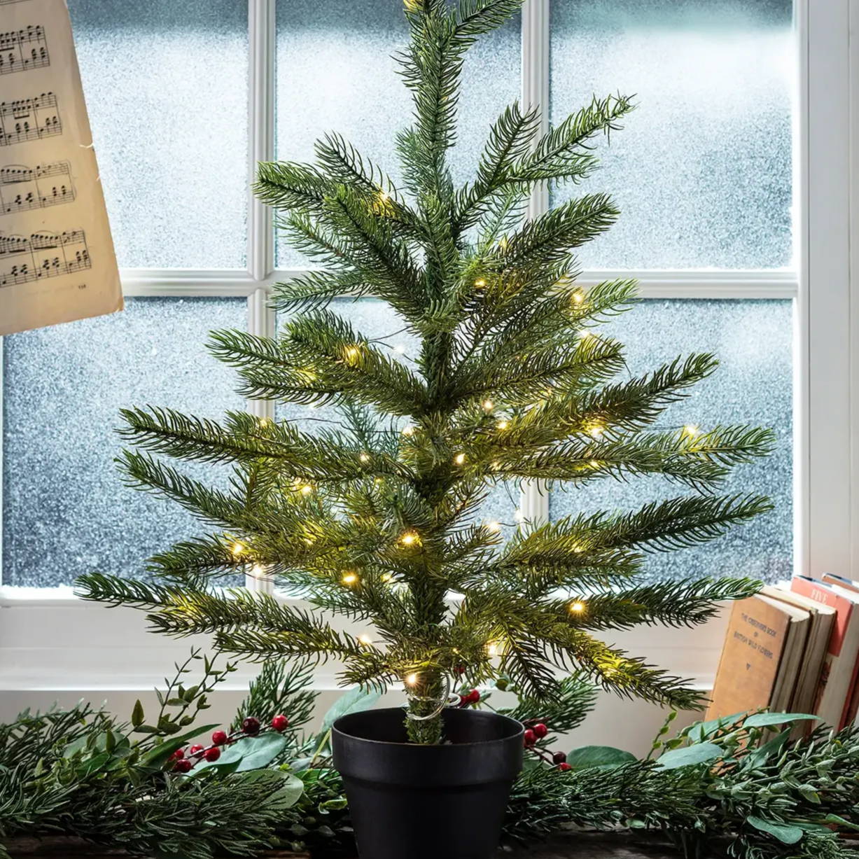 Mini Christmas tree displayed on a windowsill