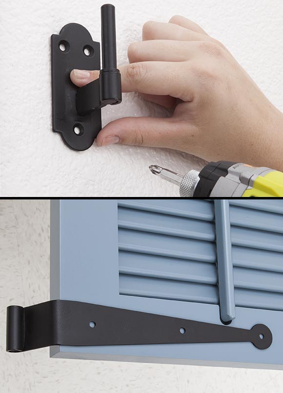 Hand installing a black latch on a wall and a window shutter.