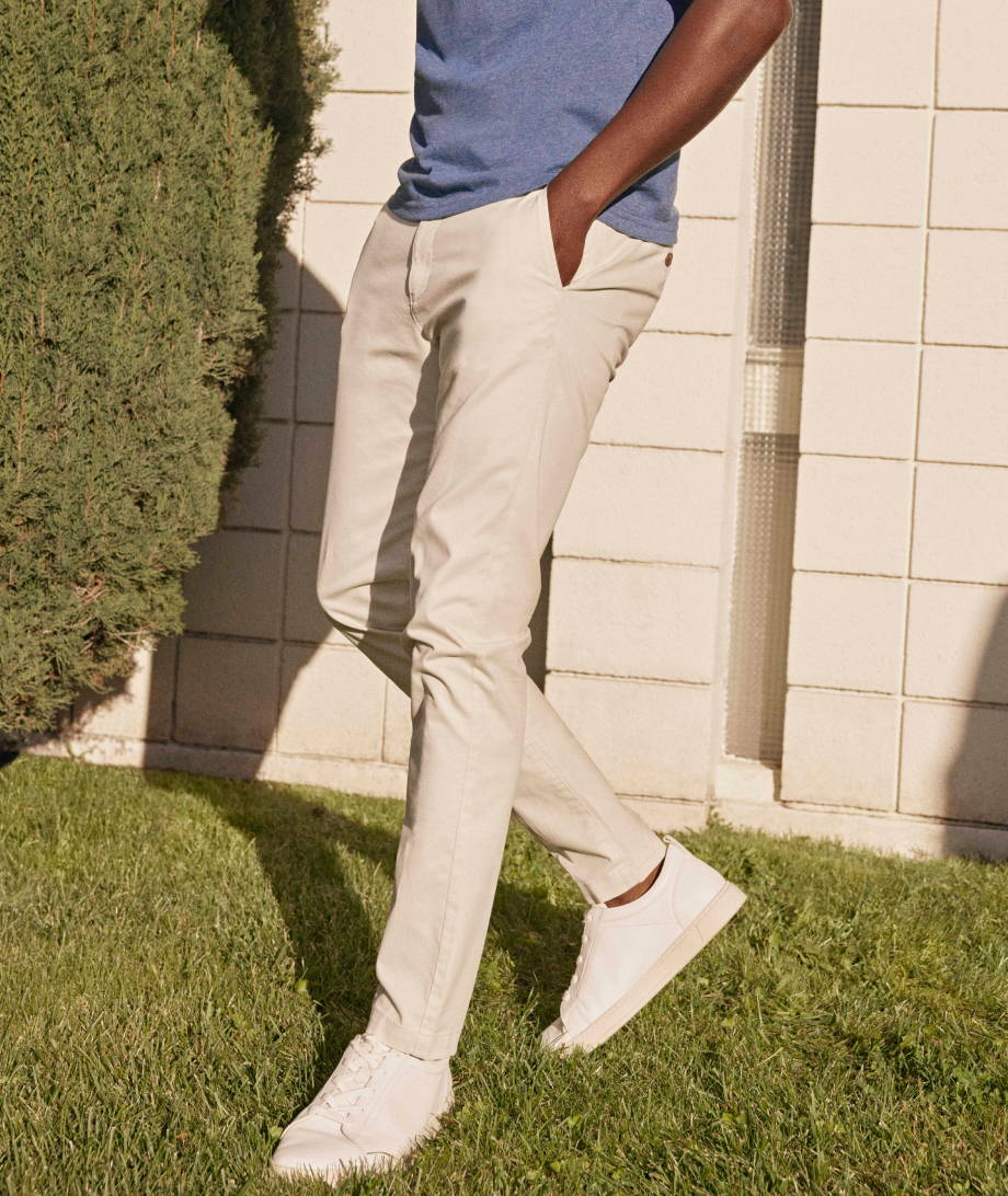 Model is wearing UNTUCKit Chino pants in stone.