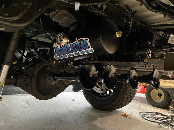 Undercarriage view of black Conductor's Special 844 Nightmare Edition train horn bells with air tank mounted under David's 2022 Silverado 2500HD, install photo 2