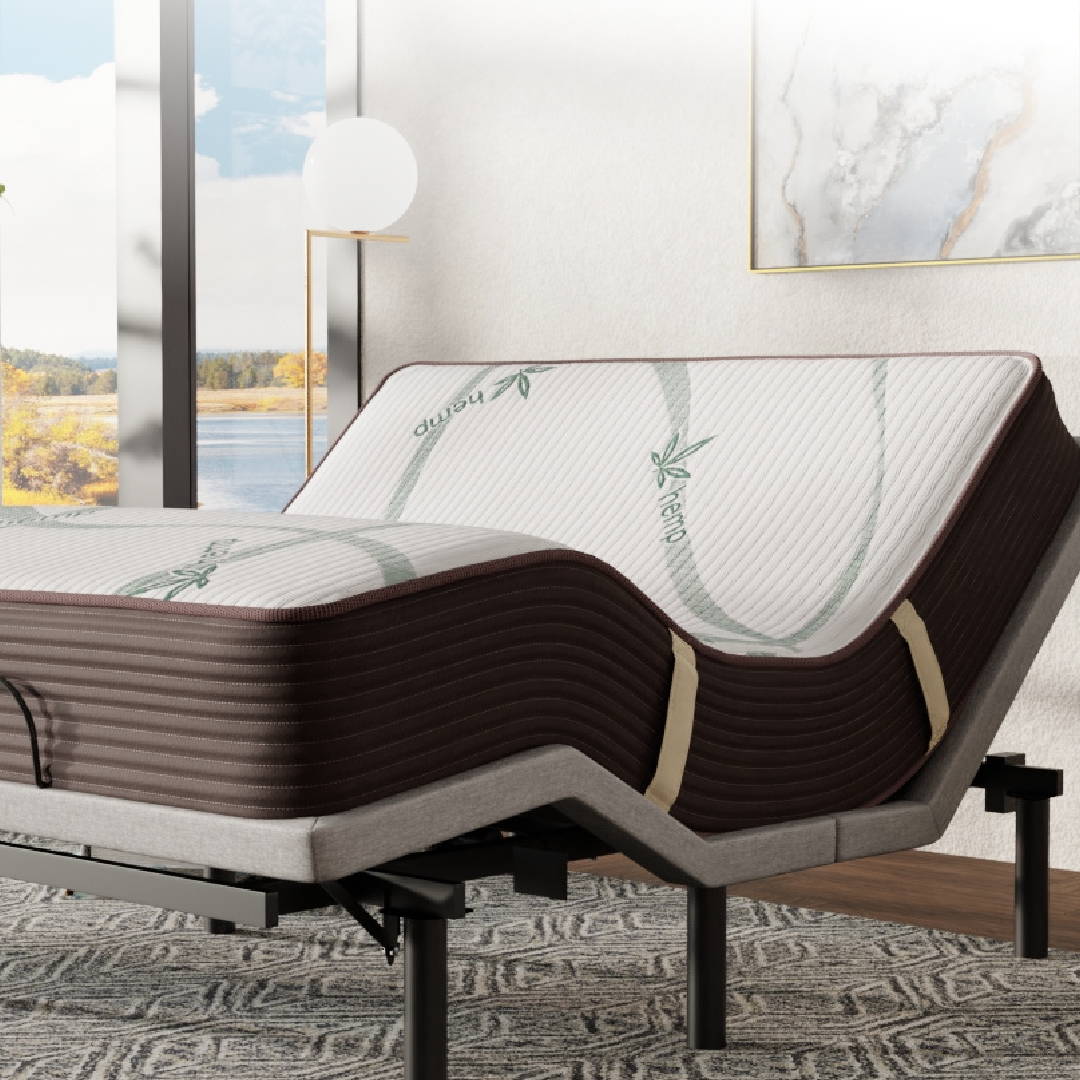 An adjustable base in the zero-gravity position with a CBD mattress on top of it in a room setting.