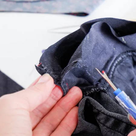 unpicking a part of the side seam of the pocket so you can open the seam about an inch or two
