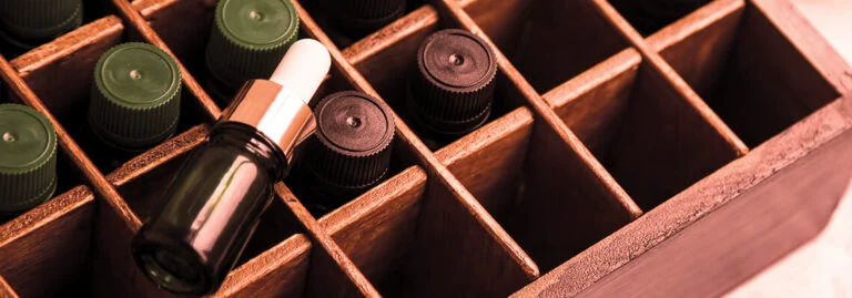 Bottles arranged in a wooden box with a focus on one bottle.