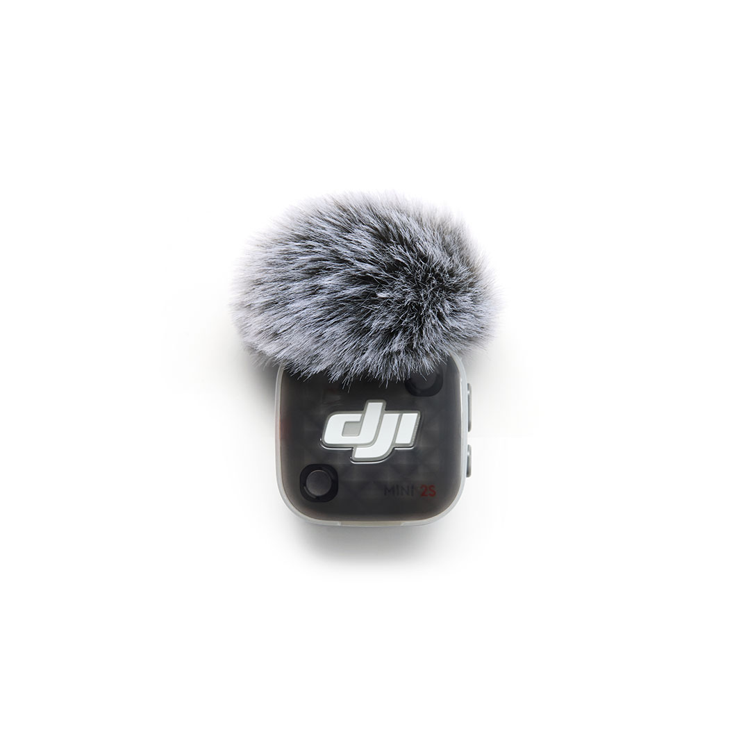 Black DJI Mic Mini 2S with a fuzzy windscreen on a white background.