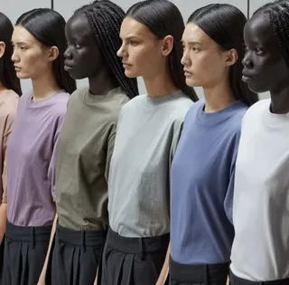 Six models wearing different colored t-shirts, standing in a row.